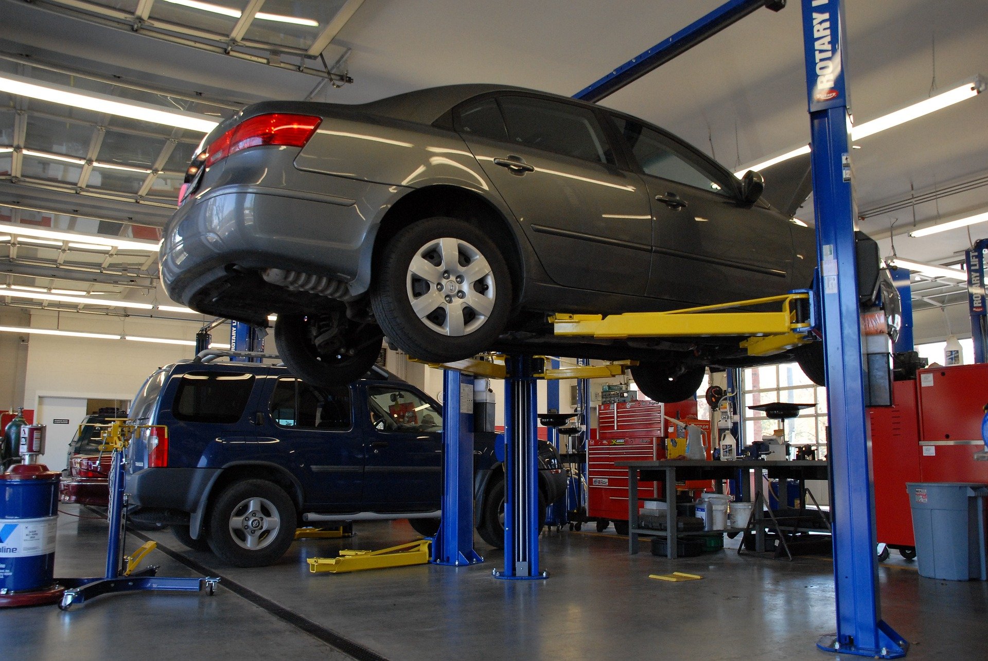 Vehicle on a lift in a workshop where you can bring spare parts