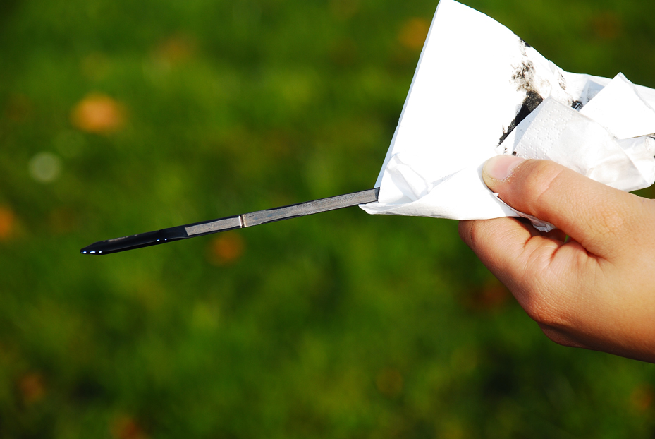 Oil dipstick is held in the hand for checking the oil level