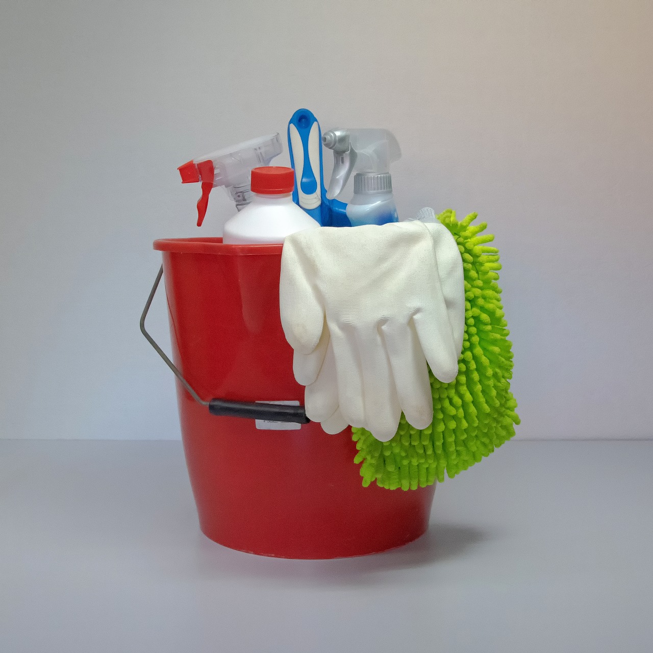 Buckets with various care products, cloths and gloves for car care